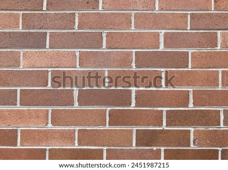 Brownish brick wall with grey mortar Royalty-Free Stock Photo #2451987215
