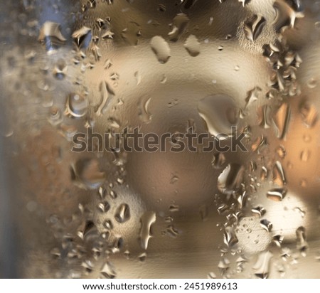 Gold background with water drops and light reflections. Square picture- Copy space