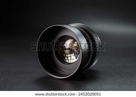 Close-up view of vintage Helios camera lens, black finish, photography gear on dark background, detailed focus rings visible, professional photographic equipment.