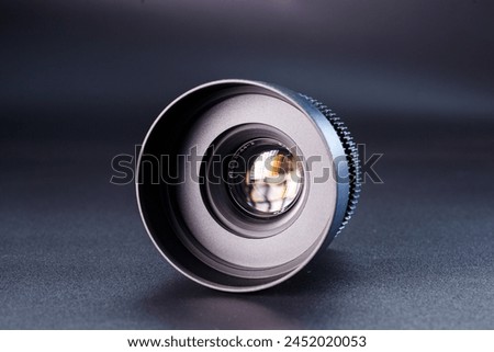 Close-up view of vintage Helios camera lens, black finish, photography gear on dark background, detailed focus rings visible, professional photographic equipment