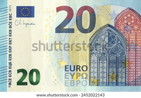 Fragment of one twenty euro money bill. Details of European union currency banknote of 20 euro close up