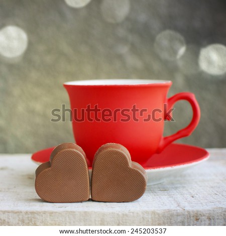 Red cup of coffee with hearts.