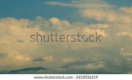 Beautiful Sunset In Mountain With Cloudy Sky. Mountains Silhouettes And Orange Golden Clouds.