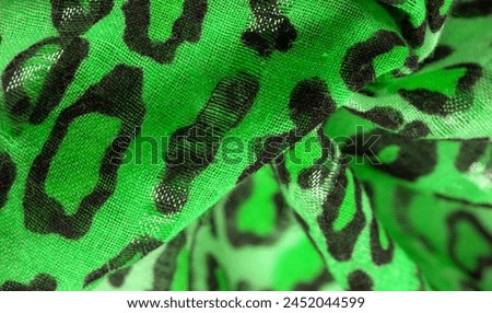 silk fabric green yellow with leopard print. Lightweight leopard print silk is perfect for your design, looks stylish and not vulgar! Texture, background, pattern