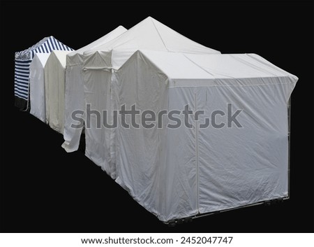 Back side of canvas tents for selling goods on the street. Isolated on black Royalty-Free Stock Photo #2452047747