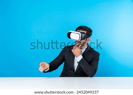 Professional businessman wearing visual reality glasses and suit while sitting. Smart caucasian project manager looking at data analysis by using VR headset. Innovation technology concept. Deviation.