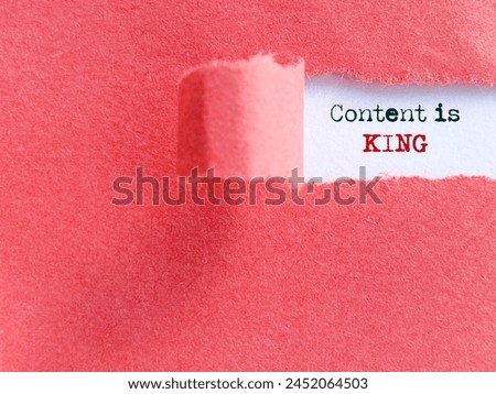 Content is king text behind torn paper background. Stock photo.