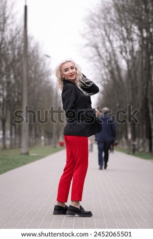 Portrait of a malty beautiful blonde girl on a city street.
