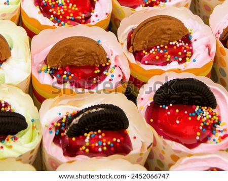a photography of a tray of cupcakes with different toppings.