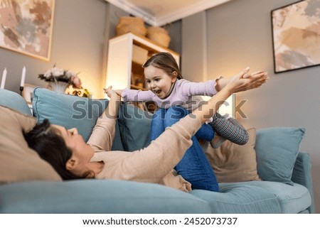 Happy day! Mom and her daughter child girl are playing, smiling and hugging. Family holiday and togetherness.
