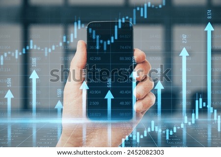 Close up of male hand holding smartphone with growing blue vertical arrows and candlestick forex chart on blurry office index grid background. Economic growth and increase concept. Double exposure