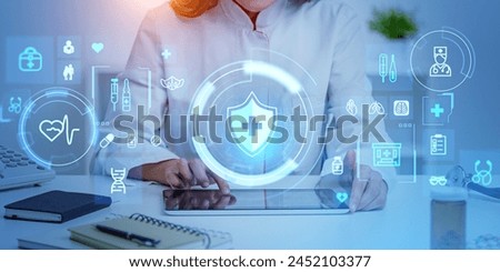 A doctor interacting with medical icons on a futuristic interface, conceptualizing advanced healthcare technology on a blue-toned workspace background