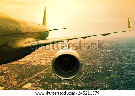 passenger jet plane flying  above urban scene  use for aircraft transportation and traveling business background Royalty-Free Stock Photo #245211379