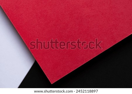 Red, black and white overlapping construction paper background