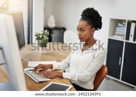 Business woman, computer and reading in office for information technology, software or online programming. African programmer or web developer typing on her desktop for planning, solution or research