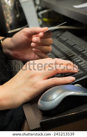 Woman shopping using computer for credit card payment