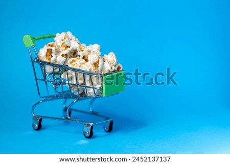 Freshly made popcorn in a shopping cart. High quality photo.