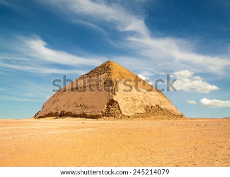 Famous Bent Pyramid under puffy clouds, Dahshur, Egypt Royalty-Free Stock Photo #245214079