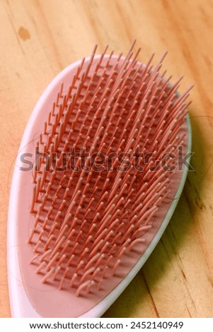 close up of pastel pink comb brush