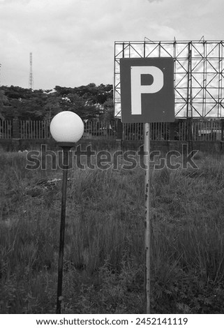 Black and white photo of Parking sign of a University