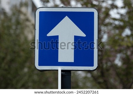 Parisian One-Way: Blue and White Arrow Street Sign in Paris, France
