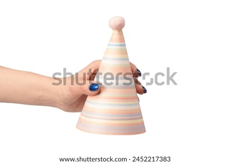 Colorful birthday cap in woman hands isolated on a white background.