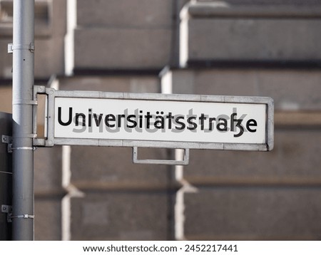 Universitätsstraße (university street) sign in Berlin. Road name guide at an intersection. The location is in the Mitte district and the famous Humboldt University is there.
