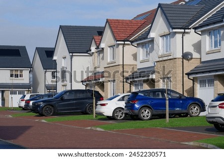 New housing development and owners cars parked outside