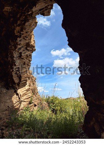 A marvellous picture, taken from inside a cave in Cyprus. The picture shows a beautiful blue sky with clouds.