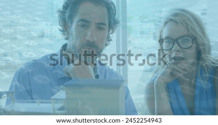 Image of data processing over diverse business people working at office. Global business, finances and digital interface concept digitally generated image.