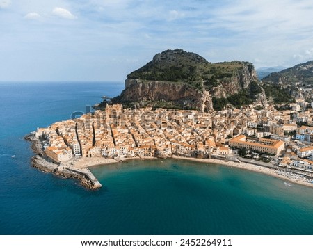 Cefalu, Italy: Aerial panorama of famous Cefalu old town with its Norman mediveval cathedral and cliff in Sicily, Italy. The town is a very popular summer holiday destination Royalty-Free Stock Photo #2452264911