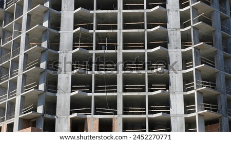 Cement frame of a high rise building under construction. Textured stock photo for modern construction illustration
