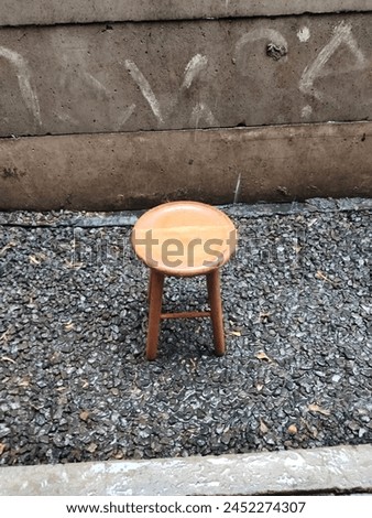 One wooden chairs under raindrops