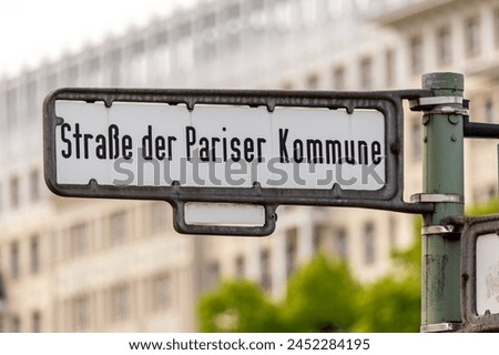 Street sign of the Street Straße der Pariser Kommune in Friedrichshain district of Berlin Royalty-Free Stock Photo #2452284195