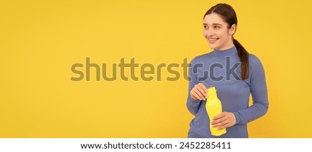 Woman isolated face portrait, banner with copy space. happy woman hold mineral water. feel thirsty. young girl with sport plastic bottle. Royalty-Free Stock Photo #2452285411