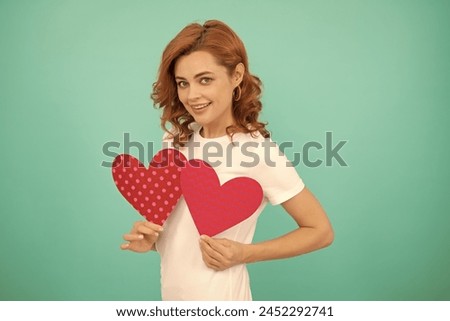 february 14. young girl with red heart on blue background