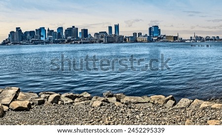 Boston skyline from East Boston, with rock beach in forground