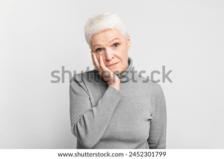 Thoughtful senior european woman appears contemplative, an apt s3niorlife depiction of reflection Royalty-Free Stock Photo #2452301799