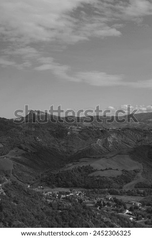 Dramatic black white photographs unveil the breathtaking beauty of Val d'Uso, showcasing the majestic peaks of Monte Carpegna, San Leo, and Monte Tiffi.