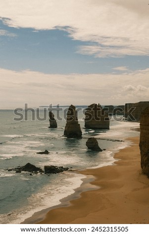 A twilight scene of the Twelve Apostles, imbued with a nostalgic darker vibe, evoking contemplation and reminiscence under the dusky sky. Royalty-Free Stock Photo #2452315505