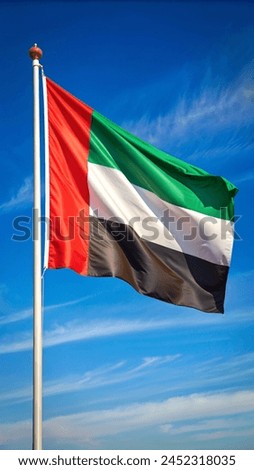 United Arab Emirates Flag Waving Against a Cloudy Sky Background. UAE Flag