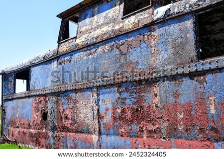 old abandoned rusty metal painted railroad train caboose Royalty-Free Stock Photo #2452324405
