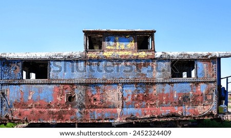 old abandoned rusty metal painted railroad train caboose Royalty-Free Stock Photo #2452324409