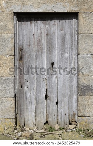 Old wooden door leading into an abandoned building