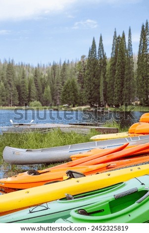 colorful kayak and pine tree forest and lake in California Royalty-Free Stock Photo #2452325819