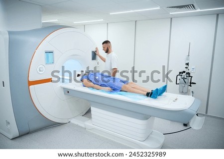 Doctor preparing man for contrast-enhanced brain magnetic resonance imaging