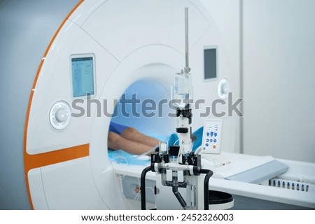 Clinic client undergoing contrast-enhanced magnetic resonance imaging procedure