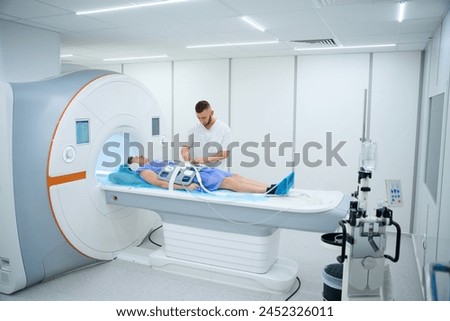 Male patient doing contrast-enhanced abdominal magnetic resonance imaging