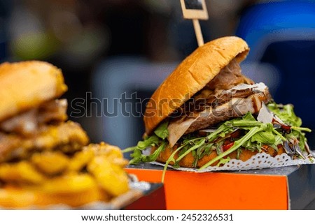 a big delicious hamburger on sale on the street