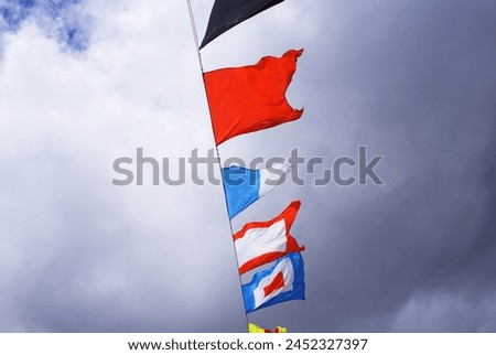 Holiday flags on a rope hanging, fluttering in the wind against the blue sky, holiday, Background.